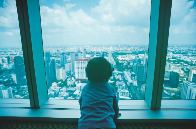 Niño mirando por la ventana